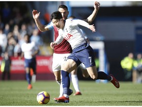 Tottenham Hotspur's Son Heung-min, front, and Burnley's Phillip Bardsley in action during their English Premier League soccer match at Turf Moor in  Burnley, England, Saturday Feb. 23, 2019.