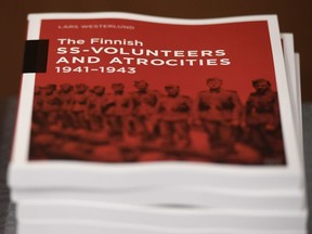 The research document entitled The Finnish SS-volunteers and atrocities 1941 - 1943 against Jews, detailing atrocities against civilians and Prisoners of War in Ukraine and the Caucasus Region, pictured in Helsinki, Finland, on Friday Feb. 8, 2019.  Senior Israeli Holocaust historian, Efraim Zuroff of the Simon Wiesenthal Center, on Sunday Feb. 10, 2019, has praised Finnish authorities for publishing a report concluding that the Nordic country's volunteer battalion serving with Nazi Germany's notorious Waffen-SS took part in atrocities during World War II including participating in the mass murder of Jews.