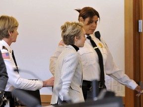 Michelle Carter, 22, center,  is led away by court officers after a hearing on her prison sentence in Taunton District Court in Taunton, Mass. Monday, February 11, 2019. Carter was jailed Monday on an involuntary manslaughter conviction. She was convicted in 2017 of involuntary manslaughter and sentenced to a 15 month prison term for encouraging 18-year-old Conrad Roy, III to kill himself when she instructed him over the phone to get back in his truck that was filling with toxic gas in July 2014.