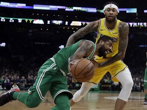 Boston Celtics guard Kyrie Irving drives against Los Angeles Lakers forward Brandon Ingram in the first quarter of an NBA basketball game, Thursday, Feb. 7, 2019, in Boston.
