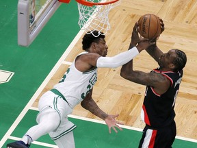 Boston Celtics guard Marcus Smart (36) fouls Portland Trail Blazers forward Al-Farouq Aminu (8) during the first half of an NBA basketball game Wednesday, Feb. 27, 2019, in Boston.