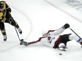 Boston Bruins's David Pastrnak (88), of Czech Republic, and Colorado Avalanche's Erik Johnson (6) vie for control of the puck during the first period of an NHL hockey game, Sunday, Feb. 10, 2019, in Boston.