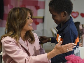 First lady Melania Trump talks with Amani, 13, of Mombasa, Kenya, during her visit to the National Institutes of Health to see children at the Children's Inn in Bethesda, Md., Thursday, Feb. 14, 2019, and celebrate Valentine's Day. Amani presented the first lady with a necklace that matches his bracelet.