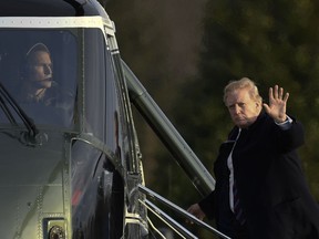 President Donald Trump waves as he walks up the steps of Marine One at Walter Reed National Military Medical Center in Bethesda, Md., Friday, Feb. 8, 2019, after having his annual physical. Trump was in for some poking and prodding as doctors assess his health during his second annual medical checkup as president.