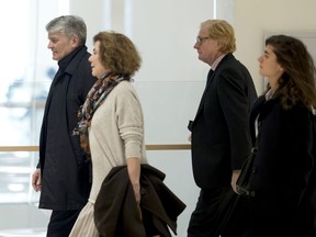 Former CEO of Global Wealth Management and Business Banking at UBS AG Raoul Weil, left, his wife, 2nd left, former General Director of UBS France Patrick de Fayet, 2nd right, and one member of their legal team arrive for the the Swiss bank's trial at the Paris courthouse in Paris, France, Wednesday, Feb. 20, 2019. A Paris court has ordered Swiss bank UBS to pay 3.7 billion euros ($4.2 billion) in fines for helping wealthy French clients evade tax authorities.