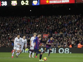 FC Barcelona's Lionel Messi kicks the ball to score a penalty kick during the Spanish La Liga soccer match between FC Barcelona and Valencia at the Camp Nou stadium in Barcelona, Spain, Saturday, Feb. 2, 2019.