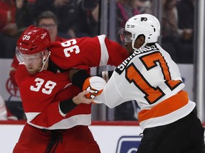 Detroit Red Wings right wing Anthony Mantha (39) and Philadelphia Flyers right wing Wayne Simmonds (17) fight during the first period of an NHL hockey game, Sunday, Feb. 17, 2019, in Detroit.