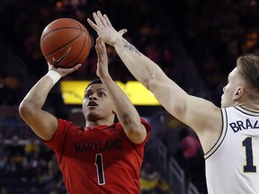 Maryland guard Anthony Cowan Jr. (1) shoots as Michigan forward Ignas Brazdeikis (13) defends during the first half of an NCAA college basketball game, Saturday, Feb. 16, 2019, in Ann Arbor, Mich.