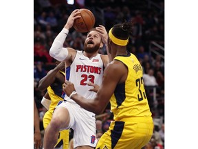 Detroit Pistons forward Blake Griffin (23) makes a layup as Indiana Pacers center Myles Turner (33) defends during the first half of an NBA basketball game, Monday, Feb. 25, 2019, in Detroit.