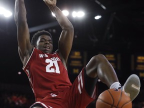 Wisconsin guard Khalil Iverson dunks during the first half of an NCAA college basketball game against Michigan, Saturday, Feb. 9, 2019, in Ann Arbor, Mich.