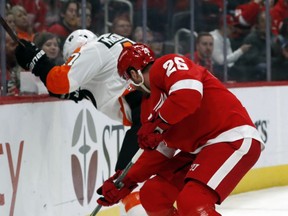 Philadelphia Flyers defenseman Andrew MacDonald (47) and Detroit Red Wings left wing Thomas Vanek (26) fight for the puck during the second period of an NHL hockey game, Sunday, Feb. 17, 2019, in Detroit.