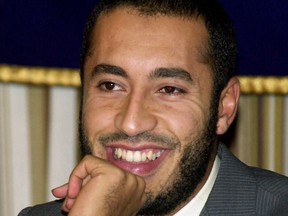 In this Tuesday, July 3, 2001 file photo, Saadi Gadhafi, son of Libyan leader Moammar Gadhafi, smiles during a press conference at the Foreign Correspondents' Club of Japan in Tokyo.