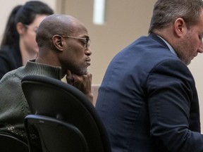 Quinn James, left, listens during Assistant Kent County Prosecutor Kellee Koncki's closing argument during his murder trial at the Kent County Courthouse in Grand Rapids, Mich., on Wednesday, Feb. 27, 2019. James, accused of killing East Kentwood High student Mujey Dumbuya, 16, after she accused him of rape, is on trial this week charged with first-degree murder.