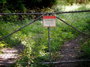 FILE - In this Aug. 16, 2017 file photo, a "No trespassing" sign is displayed at an old tannery waste dump used by Wolverine World Wide in Belmont, Mich. Some private wells in the area have tested positive for elevated levels of perfluoroalkyl and polyfluoroalkyl  substances called PFAS, also called perfluorinated chemicals, or PFCs. There's growing evidence that long-term exposure to the perfluoroalkyl and polyfluoroalkyl compounds, or PFAS, can be dangerous, even in tiny amounts.  The Environmental Protection Agency is looking at how to respond to a public push for stricter regulation of the chemicals, in production since the 1940s.  A decision is expected soon.