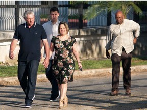 Cuba's President Miguel Diaz-Canel and his wife Lis Cuesta arrive at a polling station to cast their votes for a constitutional referendum in Havana, Cuba, on February 24, 2019. - Cubans vote on a new constitution for the first time in decades, a poll seen as a possible referendum on the role of socialism itself in the one-party state. More than eight million Cubans are registered to vote on the first new charter since 1976.