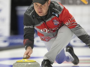 FILE - In this Feb. 9, 2019, file photo, John Shuster delivers a stone during the 2019 USA Curling Nationals at Wings Event Center in Kalamazoo, Mich. Nearly a year has passed since he won gold in South Korea, and Shuster can still smile about his transformation from obscure curler to Olympic sensation. The past 12 months have certainly been eventful for him and his teammates.