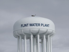 In this Feb. 26, 2016 photo, the Flint Water Plant tower is shown in Flint, Mich. Michigan Gov. Gretchen Whitmer is restructuring the state agency that drew criticism for its handling of the Flint water crisis under former Gov. Rick Snyder.