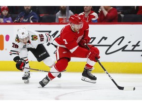 Detroit Red Wings defenseman Nick Jensen (3) skates with the puck from Chicago Blackhawks right wing Dylan Sikura (95) in the third period of an NHL hockey game Wednesday, Feb. 20, 2019, in Detroit.