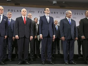 Poland's Minister of Foreign Affairs Jacek Czaputowicz, United States Vice President Mike Pence, Prime Minister of Poland Mateusz Morawiecki, Israeli Prime Minister Benjamin Netanyahu and United State Secretary of State Mike Pompeo, from left, stand on a podium at a conference on Peace and Security in the Middle East in Warsaw, Poland, Thursday, Feb. 14, 2019. The Polish capital is host for a two-day international conference, co-organized by Poland and the United States.