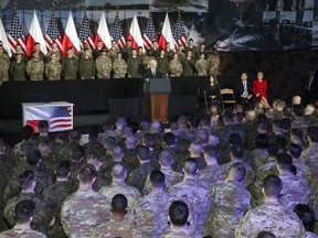 United States Vice President Mike Pence, center, holds a speech in front of soldiers from the United States and Poland at the airport in Warsaw, Poland, Wednesday, Feb. 13, 2019. The Polish capital is host for a two-day international conference on the Middle East, co-organized by Poland and the United States.