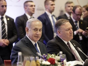 Israeli Prime Minister Benjamin Netanyahu, left, sits beside United State Secretary of State Mike Pompeo, right, at a conference on Peace and Security in the Middle East in Warsaw, Poland, Thursday, Feb. 14, 2019. The Polish capital is host for a two-day international conference, co-organized by Poland and the United States.