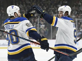 St. Louis Blues' Ryan O'Reilly (90) congratulates teammate Vladimir Tarasenko (91), of Russia on scoring a goal against the Minnesota Wild during the first period of an NHL hockey game Sunday, Feb. 17, 2019, in St. Paul, Minn.