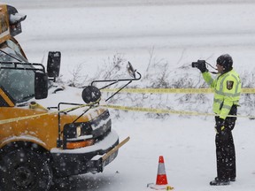 The driver of a school bus was taken to the hospital in a shooting on HWY 35 near downtown Minneapolis, Tuesday, Feb. 5, 2019. Authorities say a school bus driver was wounded in a shooting that followed a crash with another vehicle on a snowy interstate near downtown Minneapolis.