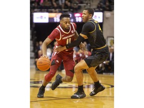 Arkansas's Keyshawn Embery-Simpson, left, dribbles past Missouri's Javon Pickett, right, during the first half of an NCAA college basketball game Tuesday, Feb. 12, 2019, in Columbia, Mo.