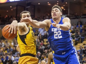 Missouri's Reed Nikko, left, and Kentucky's Reid Travis reach for a rebound during the first half of an NCAA college basketball game Tuesday, Feb. 19, 2019, in Columbia, Mo.