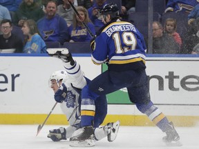 St. Louis Blues' Jay Bouwmeester (19) sends Toronto Maple Leafs' Zach Hyman (11) to the ice, after a collision during the first period of an NHL hockey game Tuesday, Feb. 19, 2019, in St. Louis.