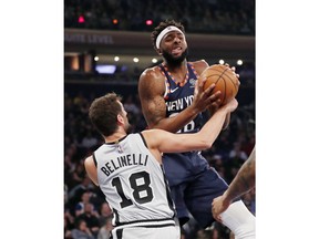San Antonio Spurs guard Marco Belinelli (18) tries to strip the ball from New York Knicks center Mitchell Robinson (26) during the first half of an NBA basketball game in New York, Sunday, Feb. 24, 2019.