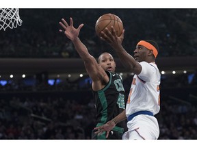 New York Knicks guard Damyean Dotson (21) goes to the basket against Boston Celtics center Al Horford (42) during the first half of an NBA basketball game Friday, Feb. 1, 2019, at Madison Square Garden in New York.