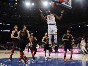 New York Knicks' Mitchell Robinson (26) dunks the ball in front of Cleveland Cavaliers' Jordan Clarkson (8) Ante Zizic (41) and Kevin Love during the first half of an NBA basketball game Thursday, Feb. 28, 2019, in New York.