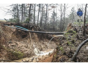 Hunter Maples looks over a water line break caused by heavy rainfall near the Max Hipp Industrial Park in Oxford, Miss. on Saturday, Feb. 23, 2019. The city of Oxford has issued a self-imposed precautionary boil-water notice for all customers that receive water from the city of Oxford, including those customers outside the city limits.