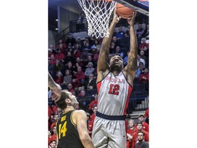 Mississippi forward Bruce Stevens (12) scores against Missouri's Reed Nikko (14) during an NCAA college basketball game in Oxford, Miss., Saturday, Feb. 16, 2019.