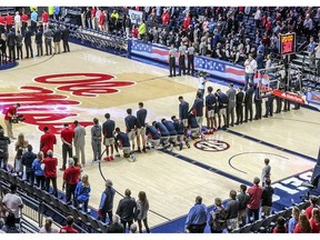 Six Mississippi basketball players take a knee during the national anthem before an NCAA college basketball game against Georgia in Oxford, Miss., Saturday, Feb. 23, 2019.