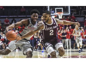 Texas A&M's TJ Starks (2) steals the ball from Mississippi guard Blake Hinson (0) during an NCAA college basketball game in Oxford, Miss., Wednesday, Feb. 6, 2019.