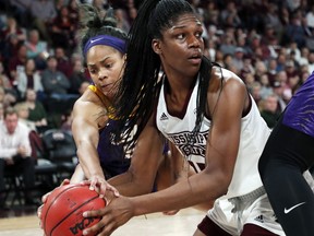 Mississippi State center Teaira McCowan (15) looks for a teammate while LSU forward Ayana Mitchell (5) reaches in to attempt a steal during the first half of an NCAA college basketball game in Starkville, Miss., Thursday, Feb. 28, 2019.