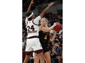 Missouri guard Sophie Cunningham (3) looks for an open teammate while Mississippi State guard Jordan Danberry (24) defends during the first half of an NCAA college basketball game, Thursday, Feb. 14, 2019, in Starkville, Miss.