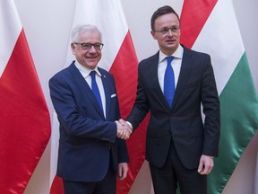 Hungarian Minister of Foreign Affairs and Trade Peter Szijjarto, right, receives Polish Minister of Foreign Affairs Jacek Czaputowicz at the Minister of Foreign Affairs and Trade in Budapest, Hungary, Wednesday, Feb. 27, 2019.