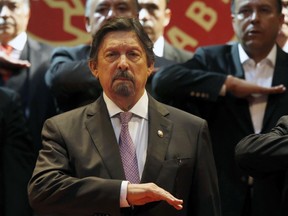 Miners' Union leader Napoleon Gomez Urrutia, who is also serves as a senator, salutes during the playing of the Mexican national anthem during the inauguration ceremony for his new International Labor Confederation (CIT) in Mexico City, Wednesday, Feb. 13, 2019. Urrutia says that 150 unions have joined the CIT and that other unions have expressed interest in joining, the latest sign that Mexico's long-dormant labor movement is awakening, and one month after massive walkouts began at border assembly plants in Matamoros.