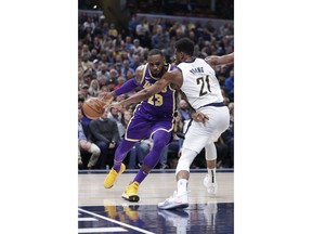 Los Angeles Lakers forward LeBron James (23) drives on Indiana Pacers forward Thaddeus Young (21) during the first half of an NBA basketball game in Indianapolis, Tuesday, Feb. 5, 2019.