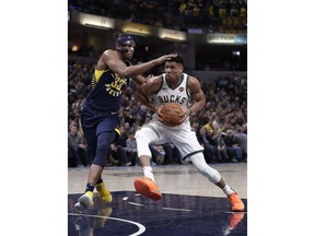 Milwaukee Bucks forward Giannis Antetokounmpo (34) drives on Indiana Pacers center Myles Turner (33) during the second half of an NBA basketball game in Indianapolis, Wednesday, Feb. 13, 2019. The Bucks defeated the Pacers 106-97.