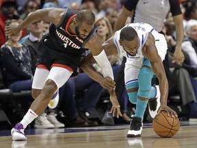 Charlotte Hornets' Kemba Walker, right, and Houston Rockets' Chris Paul, left, chase a loose ball during the first half of an NBA basketball game in Charlotte, N.C., Wednesday, Feb. 27, 2019.