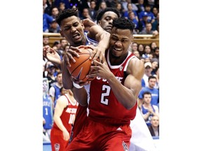 Duke's Javin DeLaurier (12) and North Carolina State's Torin Dorn (2) battle for the ball during the first half of an NCAA college basketball game in Durham, N.C., Saturday, Feb. 16, 2019.