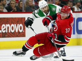 Carolina Hurricanes' Andrei Svechnikov (37) trips over Dallas Stars' Andrew Cogliano (17) during the first period of an NHL hockey game, Saturday, Feb. 16, 2019, in Raleigh, N.C.