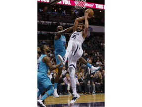 Memphis Grizzlies center Joakim Noah, right, pulls in a rebound against Charlotte Hornets center Bismack Biyombo (8) as Charlotte Hornets guard Kemba Walker (15), left, looks on in the first half of an NBA basketball game in Charlotte, N.C., Friday, Feb. 1, 2019.