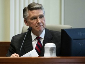 FILE - In this Thursday, Feb. 21, 2019, file photo, Mark Harris, Republican candidate in North Carolina's 9th congressional race, makes a statement before the state board of elections calling for a new election during the fourth day of a public evidentiary hearing on the 9th congressional district voting irregularities investigation at the North Carolina State Bar in Raleigh, N.C. Harris, whose narrow lead in the North Carolina congressional race was thrown out because of suspicions of ballot fraud, announced Tuesday, Feb. 26, 2019, he will not run in the newly ordered do-over election, saying he needs surgery in late March.