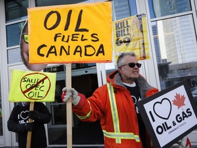 Oil and gas supporters picket outside the National Energy Board, during the release of the board's reconsideration report on marine shipping related to the Trans Mountain expansion project, in Calgary, Alta., Friday, Feb. 22, 2019.