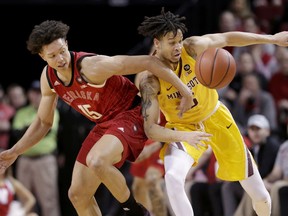 Minnesota's Amir Coffey (5) fouls Nebraska's Isaiah Roby (15) during the first half of an NCAA college basketball game in Lincoln, Neb., Wednesday, Feb. 13, 2019.